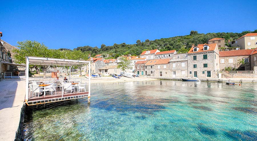 A beach and houses in Sudard on the island of Sipan near Dubrovnik